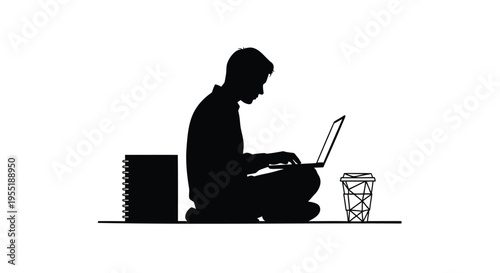 Black silhouette of a person sitting cross-legged, typing on a laptop with a notebook and coffee cup
