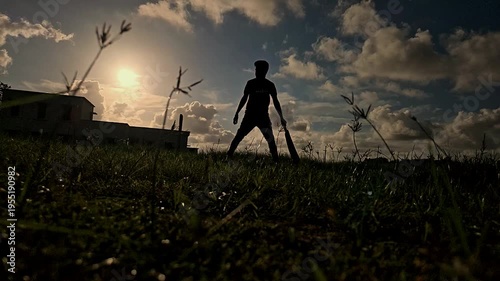 Cricket player silhouette practicing with bat at sunset, golden hour sports scene with dramatic sky and sun rays, outdoor training in rural ground representing passion, fitness Indian sports culture