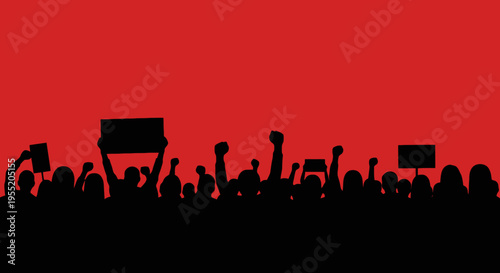 Silhouette of crowd with raised fists.