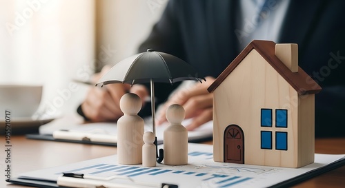 Family protected by insurance umbrella standing in front of a house model