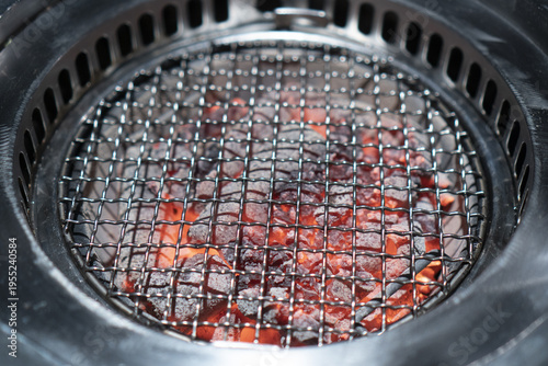 Grill with hot charcoal glo...