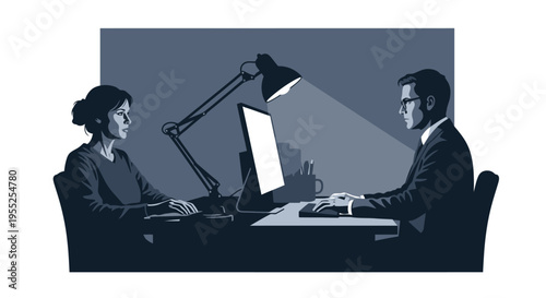 Business colleagues working diligently on computers in dim office