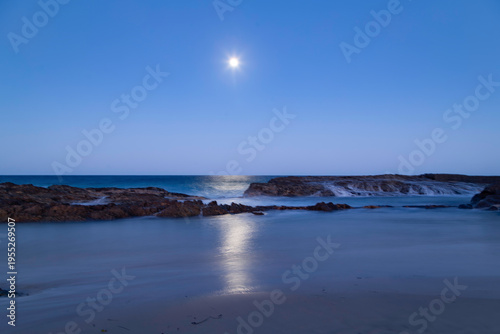 the coast at night with moon rise