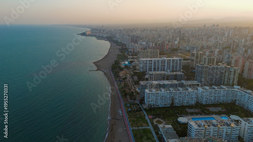 Wallpaper Mural Mersin, Turkey. Drone view of Mediterranean coastline with sandy beaches, high-rise residential quarters and seaside promenade at golden hour.. Aerial View Torontodigital.ca