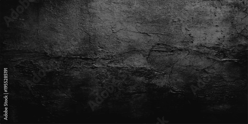 A dark and dirty grunge wall background with a rough stone texture and aged black concrete surface creates a vintage gray paper pattern backdrop
