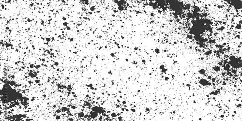 A close-up view of dark ink splatter, capturing the abstract textures and patterns, creates a dynamic, grungy artistic impression.