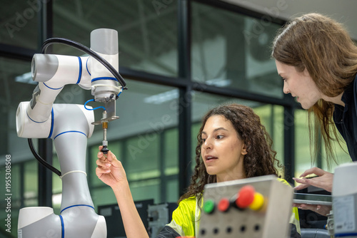 Konstfotografi Robotics Education: Female Engineers with a Laptop, Focused on a Robotic Arm Fem