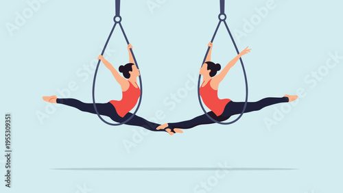 Two professional aerial yoga performers in red tops and black leggings executing graceful split poses while hanging from silk hoops.