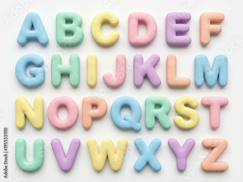 Full set of pastel-colored alphabet letters, A to Z, crafted from soft, puffy material, neatly arranged on a white background, representing early childhood education and playful learning