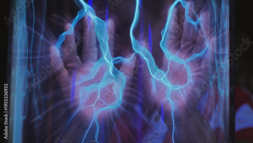 Фотография Hand interacting with glowing plasma energy in a science experiment