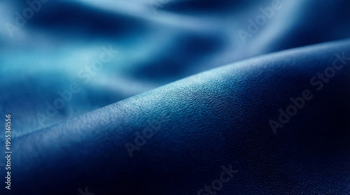 Fotografie Close-up abstract photograph revealing the rich, textured surface of dark blue leather, with gentle waves and gradients