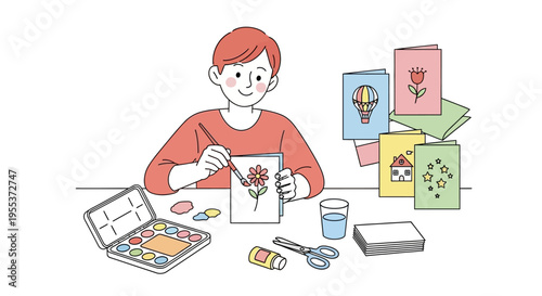 Boy making greeting cards at desk.
