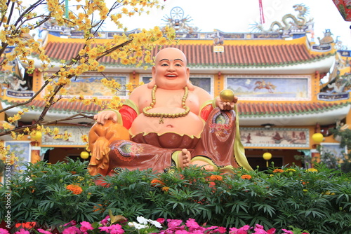 Happy Buddha outside Phap Bao Pagoda Hoi An during Tet, Vietnam