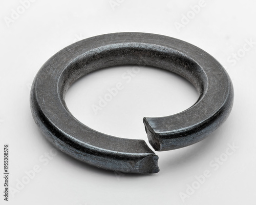 Fotografie Macro image of black split lock washer isolated on white, symbol of threaded fastening and security