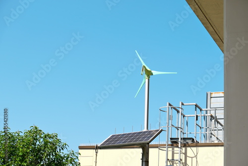 Solar Panel and Small Wind Turbine with Blue Sky Background