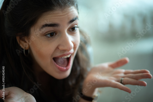 Surprised woman open mouth shocked expression confused gesture raised eyebrows casual home emotional reaction talking female adult close up portrait Surprised woman with open mouth and shocked