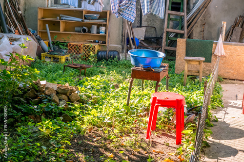 a collection of items, largely categorized as junk or scrap materials, commonly found in a cluttered outdoor storage area or shed