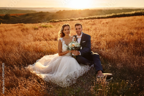 Romantic couple sitting in a sunset field holding a wedding bouquet, wide banner background, Generative AI