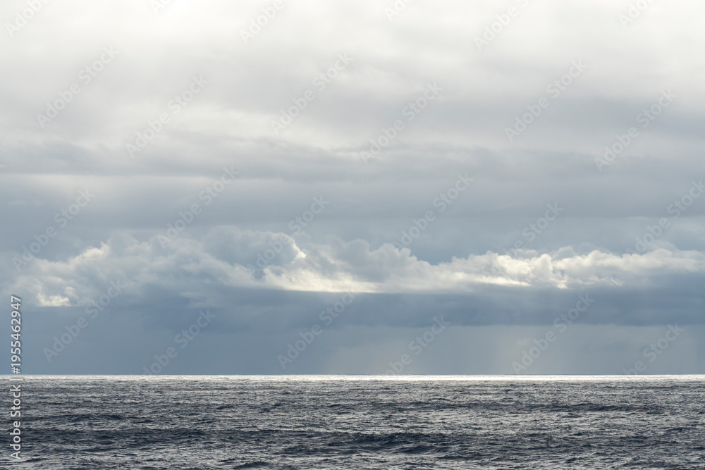 Obraz premium Storm clouds over the Mediterranean Sea at sunset, sailing on a cruise ship towards the strait.