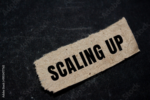 Scaling Up message written on ripped torn paper background. Conceptual Scaling Up symbol. Copy space.