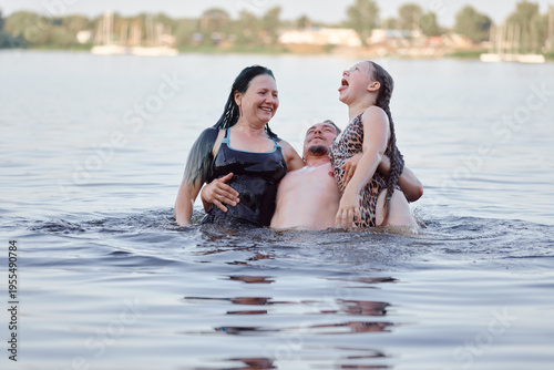 A joyful family bonding in a lake, sharing laughter and creating cherished memories during summer.
