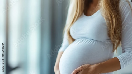A serene portrayal of a pregnant woman gently holding her baby bump while wearing a light top, capturing the beauty and joy of motherhood in a soft, natural setting. Free Download A serene portrayal of a pregnant woman gently holding her baby bump while wearing a light top, capturing the beauty and joy of motherhood in a soft, natural setting. - GFXLoad