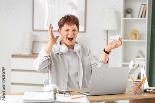 Angry young man with crumpl...
