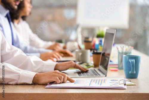 Group of business people working at desk in office, closeup