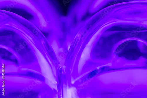 Abstract Composition of upside down plastic egg carton reflecting purple light.