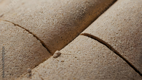 Close-up of a golden-brown, rough-textured baked bread, sliced into segments, highlighting its crust and crumb