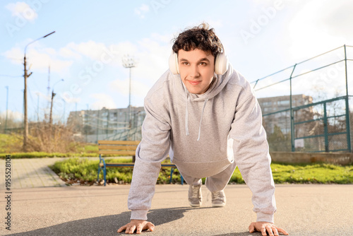 Young man in grey sports su...