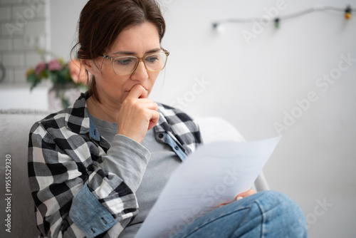 Obraz na płótnie Girl In Glasses Reading Unpleasant Notice With Financial Information