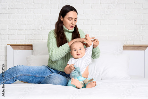Young mother putting t-shir...