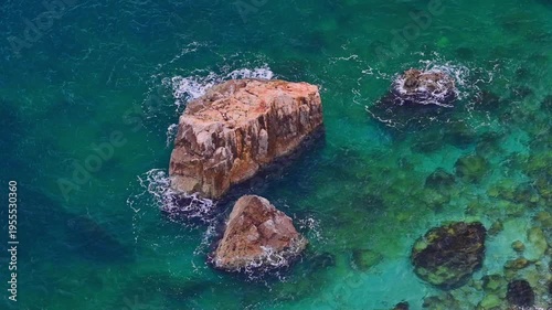 Peaceful turquoise water on the coastline rocky coastline
