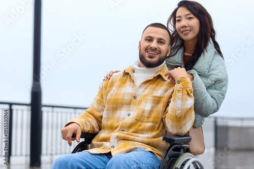 Young man in wheelchair wit...