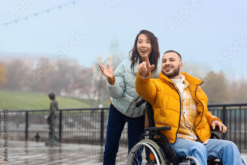 Young man in wheelchair poi...