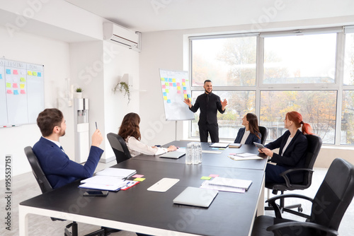 Group of colleagues discuss...