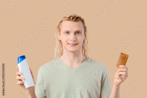 Young blonde man with shamp...