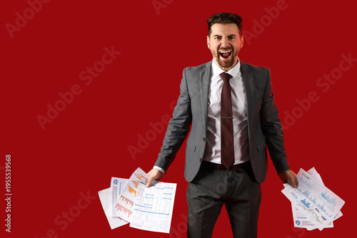 Angry businessman with pape...