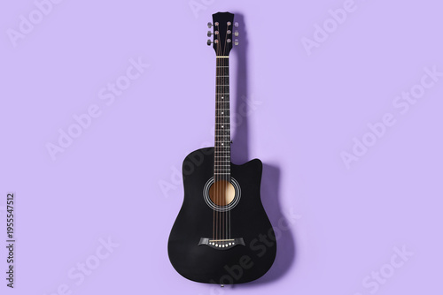 Black acoustic guitar on li...