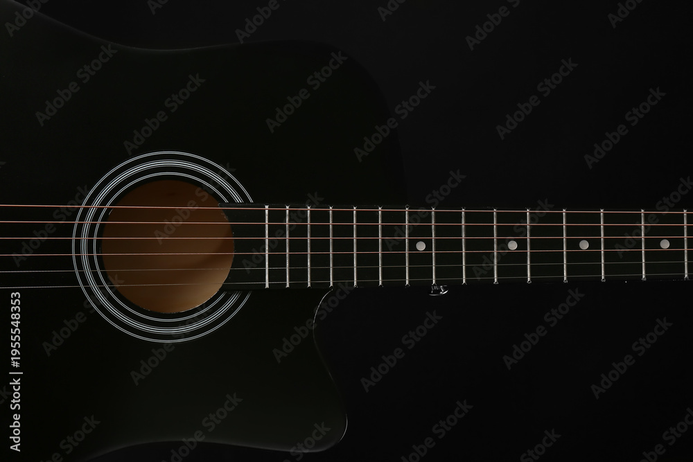 Obraz premium Modern black guitar on dark background, closeup