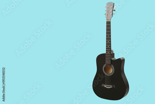 Modern black guitar on blue...