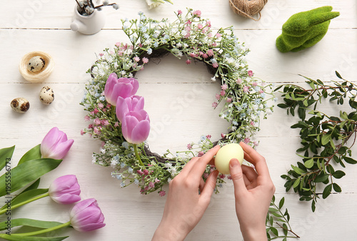 Woman decorating Easter wre...
