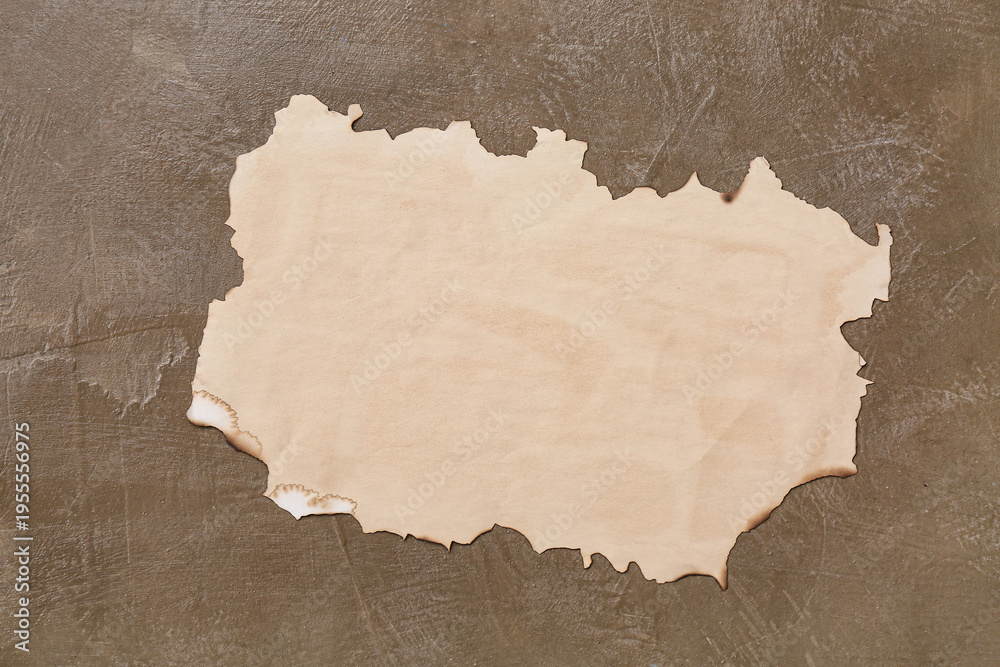 Fototapeta premium Burnt paper sheet on grunge background