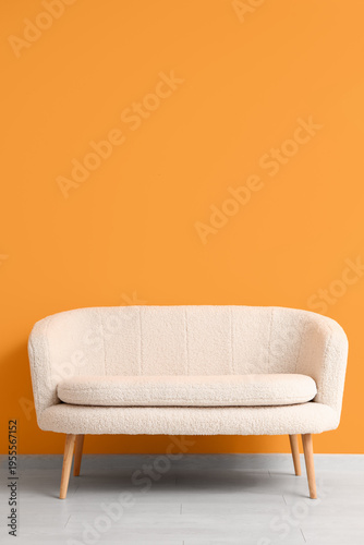 Cozy white sofa near orange...