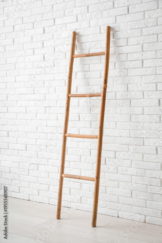 Wooden ladder near white br...