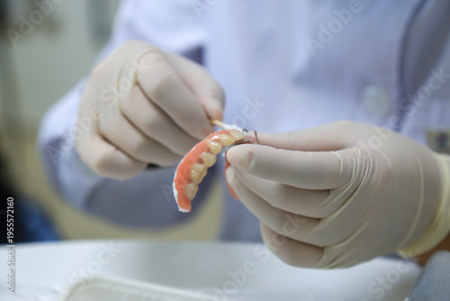Dental Professional Performing Maintenance on a Removable Partial Denture