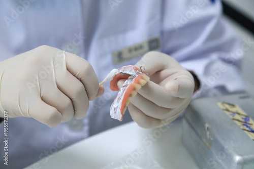 Dental Professional Performing Maintenance on a Removable Partial Denture