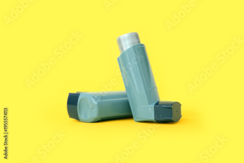 Asthma inhalers on yellow b...