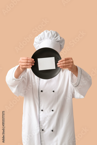 Female chef holding plate w...